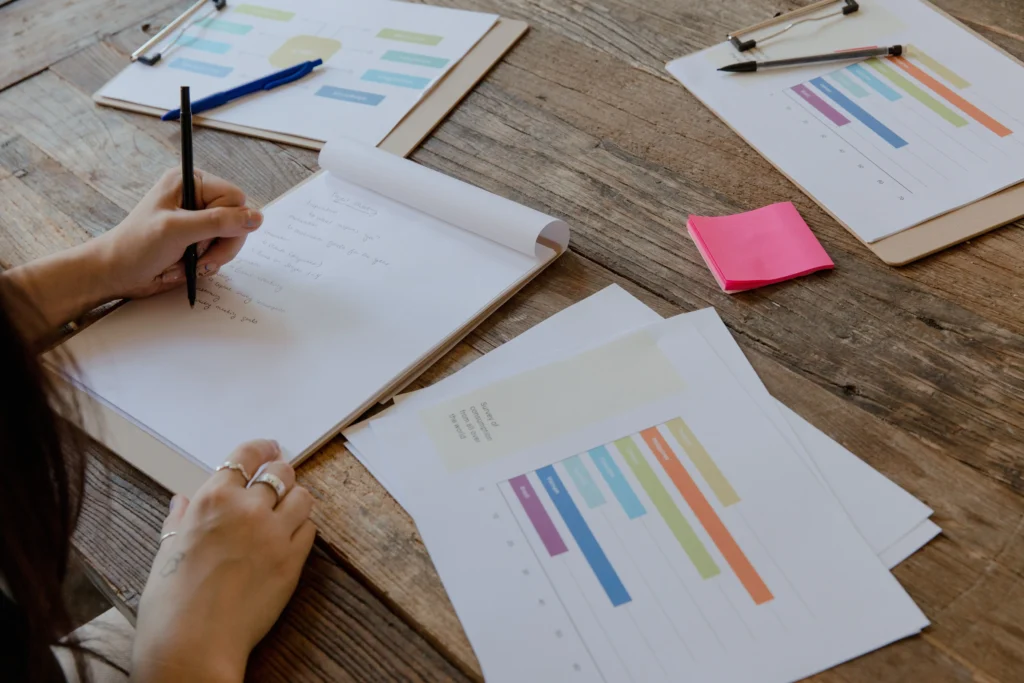 Compliance officer reviewing a Data Protection Impact Assessment report and data charts on a wooden desk under Swiss FADP and GDPR