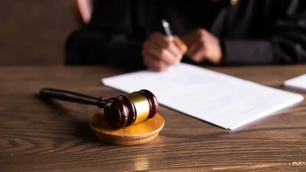Legal gavel on a wooden desk with a signed document representing Swiss FADP individual criminal liability versus EU GDPR fines
