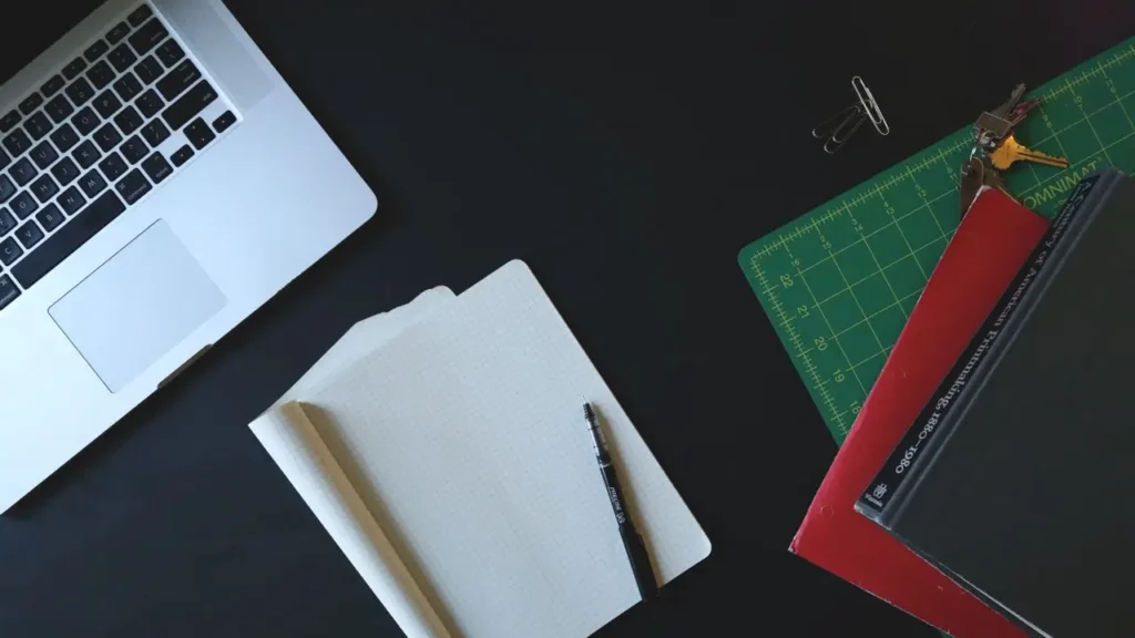 Laptop and open notebook on a workspace desk setup for hands-on comparison of three machine learning models