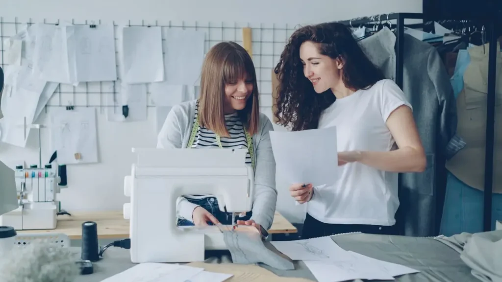 Fashion studio entrepreneurs reviewing plans illustrating what machine learning looks like for a small business